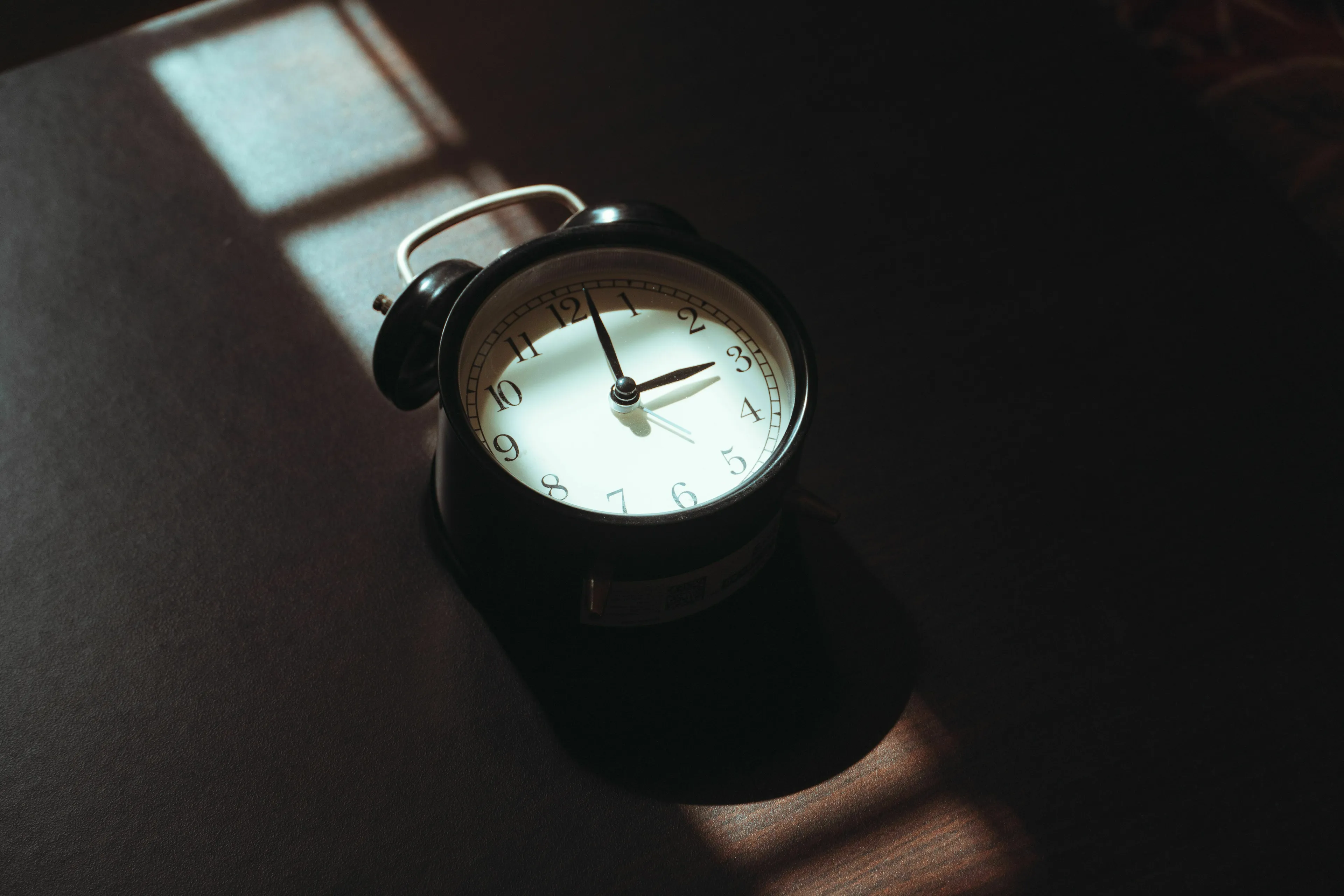 A vintage alarm clock showing 2:45, representing a curfew and relationship with rules.