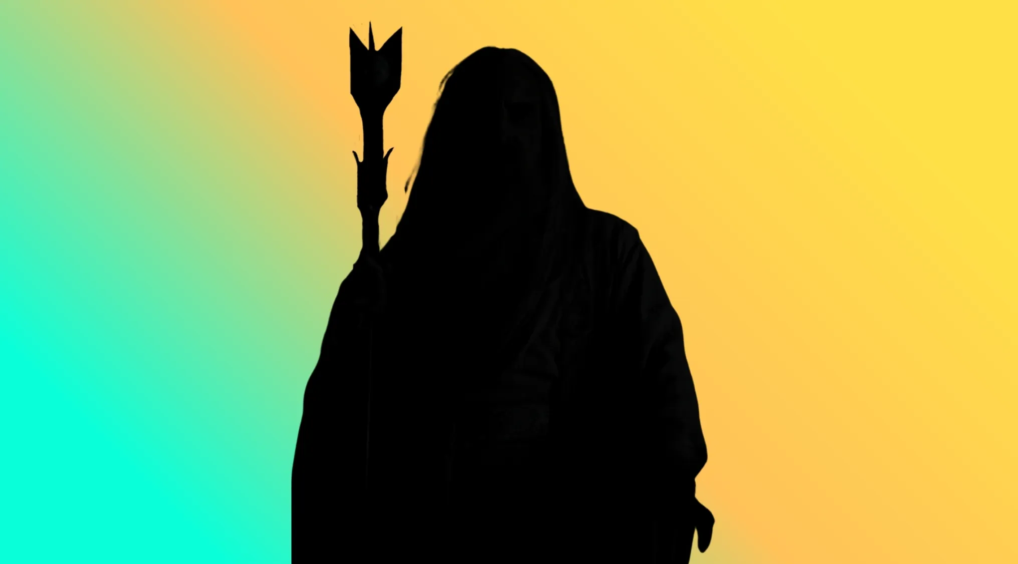 A character silhouette of a mysterious figure in a hooded cloak holding a staff, against a bright background.