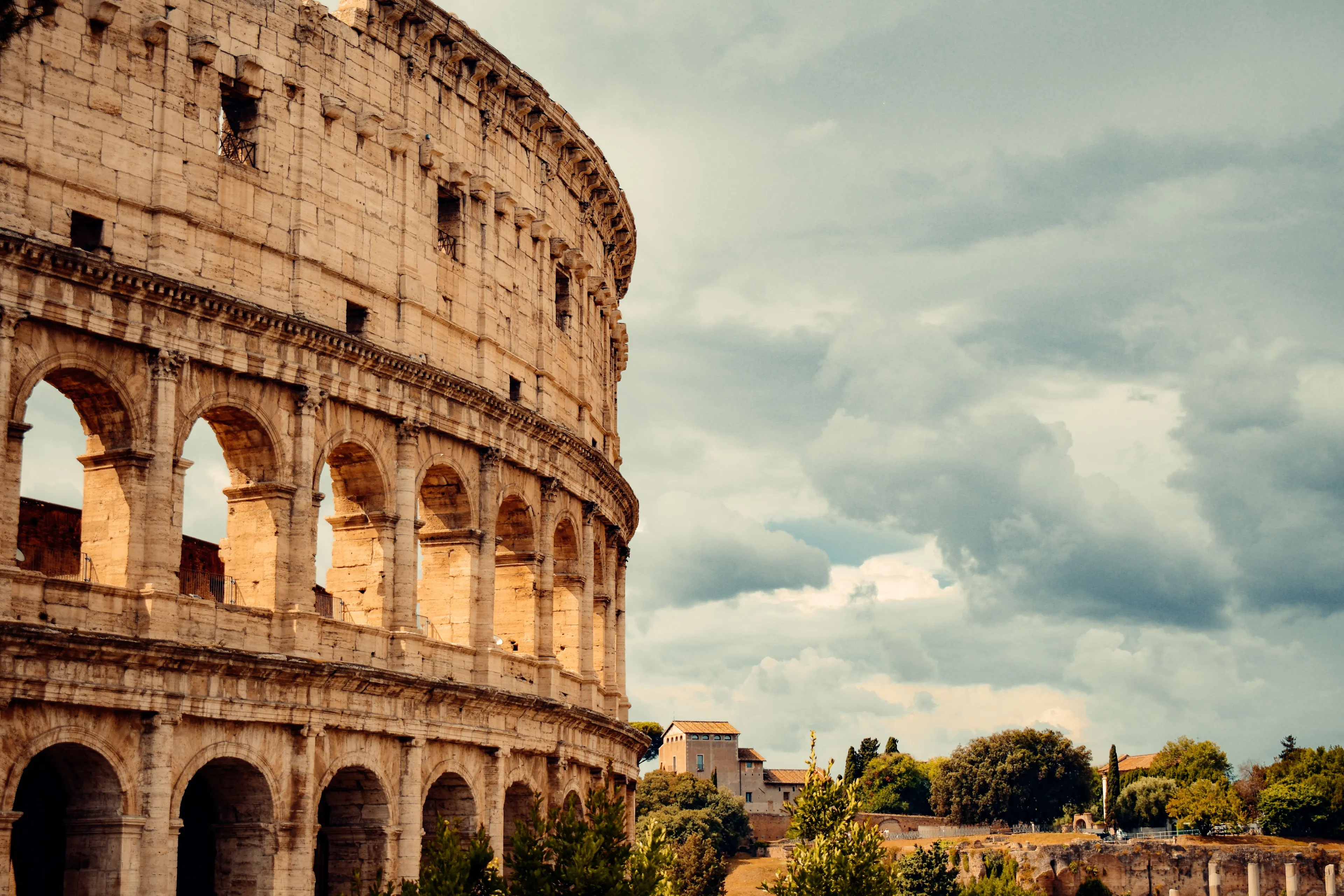 Magnificent ancient Roman Colosseum under a cloudy sky, showcasing historical era architecture.