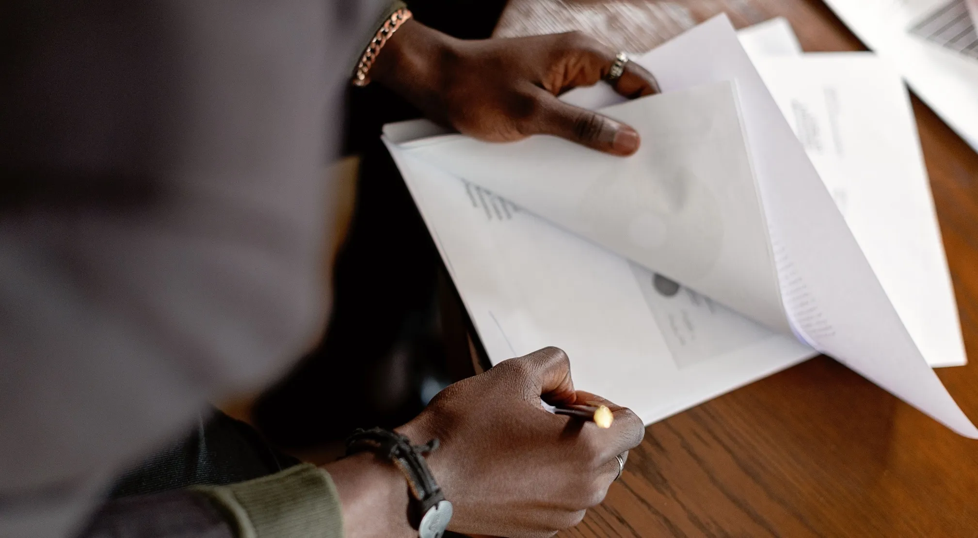A person inspecting documents for a WWI Recruit Test, highlighting the need for accurate reporting during close examination.