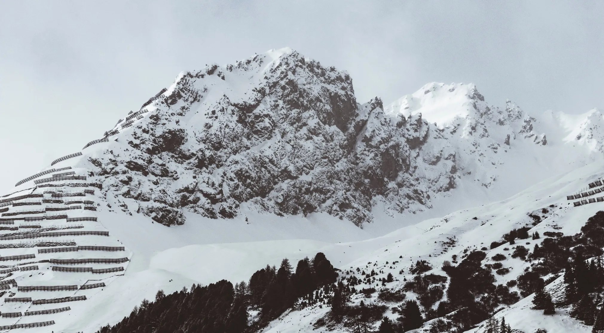 Snow-covered mountains with avalanche barriers, revealing the force of avalanches descending mountains. WWI recruit test.