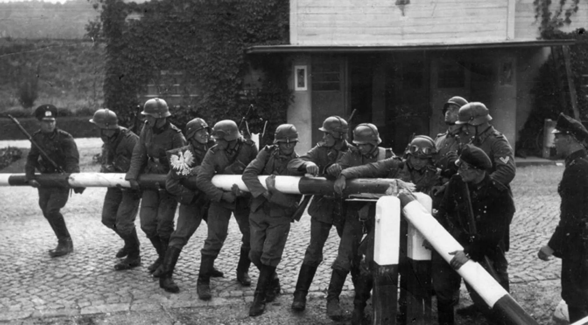 German soldiers, World War II era, moving a border barrier after the invasion of Poland. France also declared war.