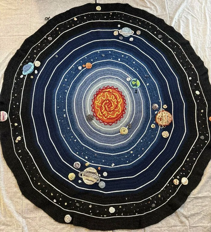 Creative crochet project of a solar system blanket with planets and sun