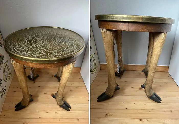 Two views of a bizarre table with hoofed animal legs and a brass top, a crazy furniture design.