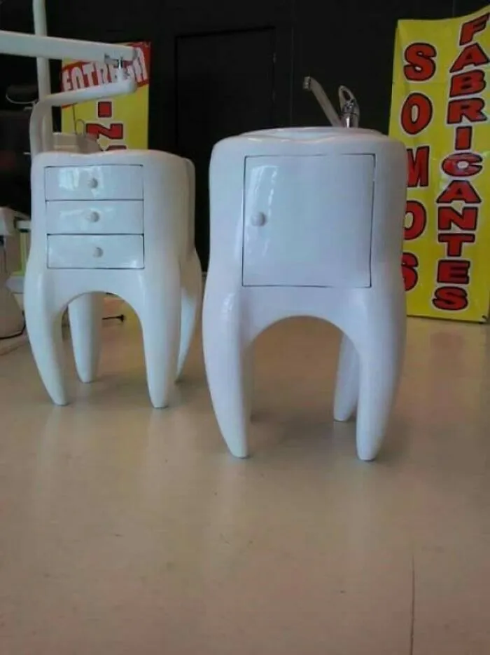 Two white tooth-shaped cabinets, one with drawers, another with a door, demonstrating bizarre furniture design.