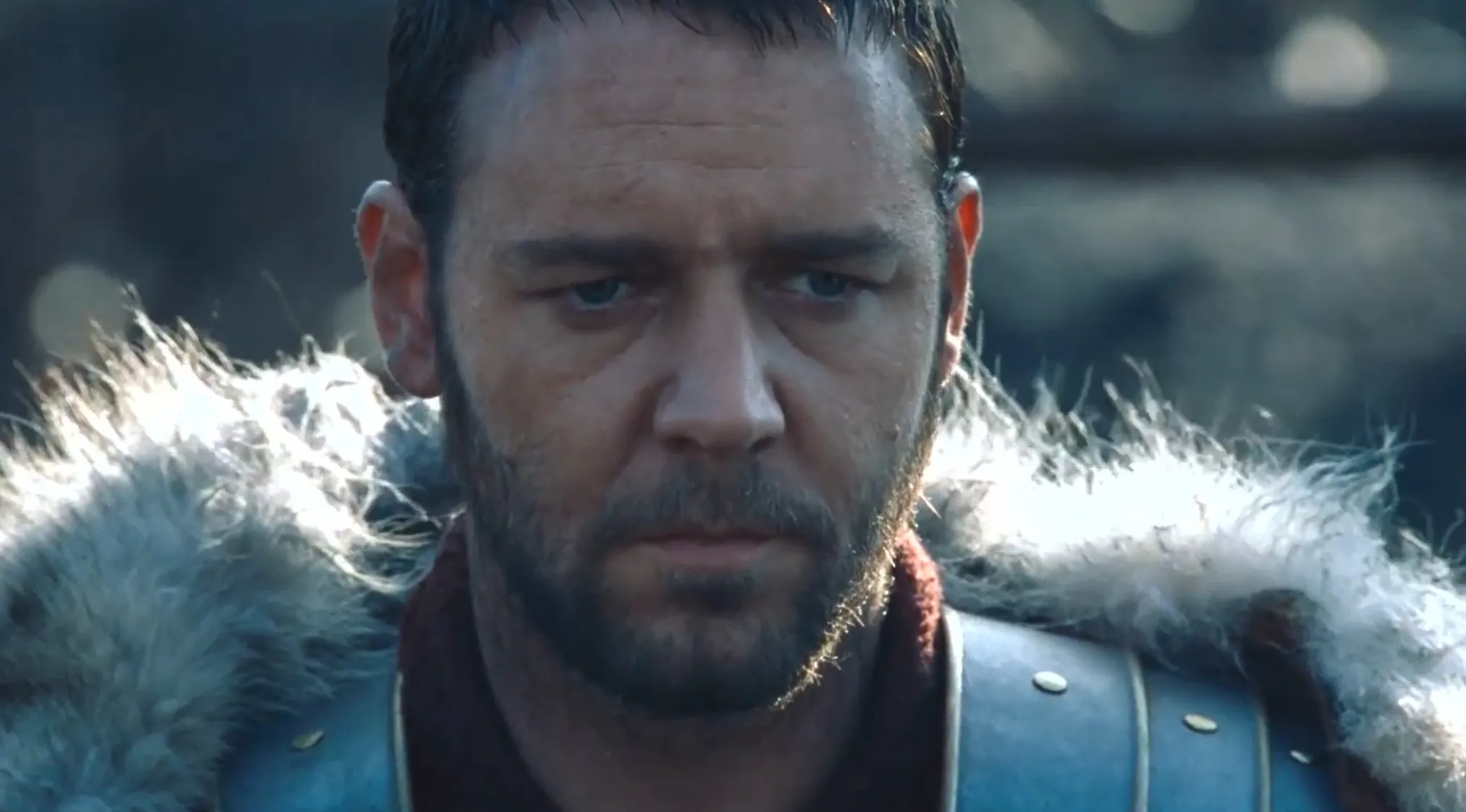 A close-up of Russell Crowe as Maximus in the opening movie scene of Gladiator, looking determined before battle.