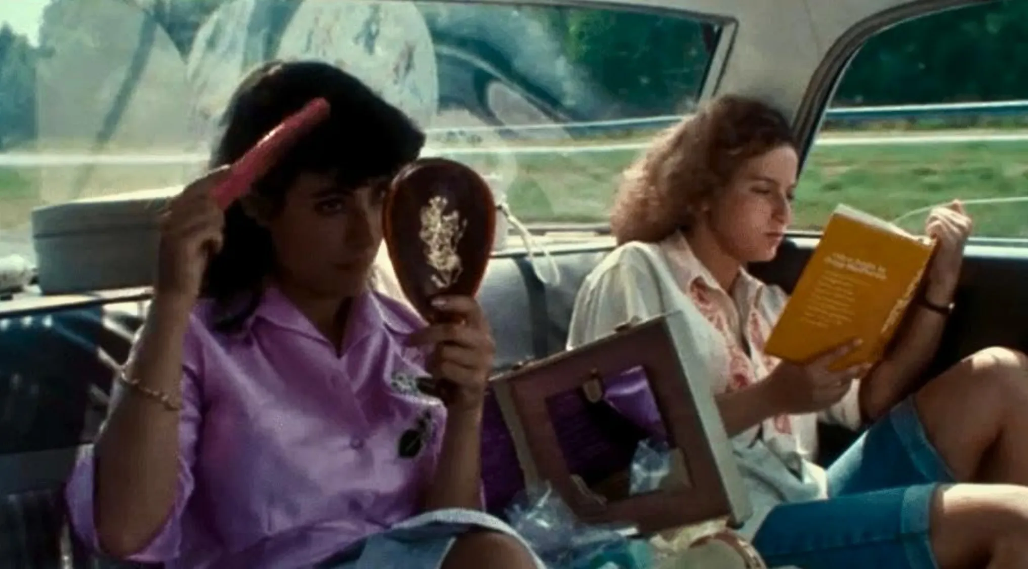Opening Movie Scenes: Two women in a car, one brushing her hair, in this film's opening scene.
