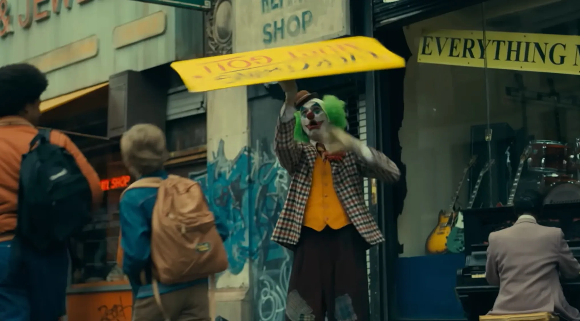 Opening Movie Scenes: A clown twirls a sign on a city street, identifying this film's opening scene.