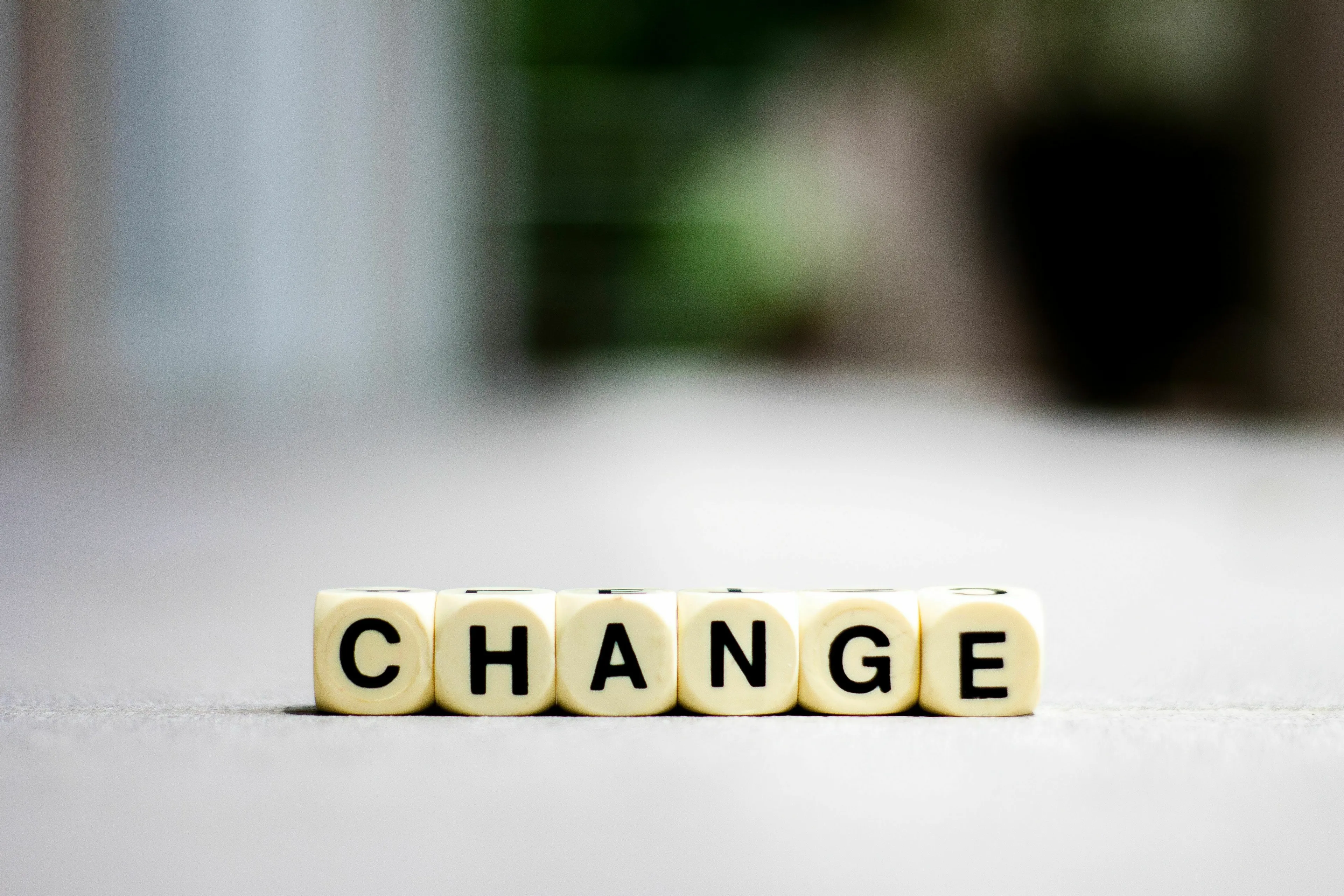Dice spelling out CHANGE, symbolizing one's relationship with change and the extinct species.