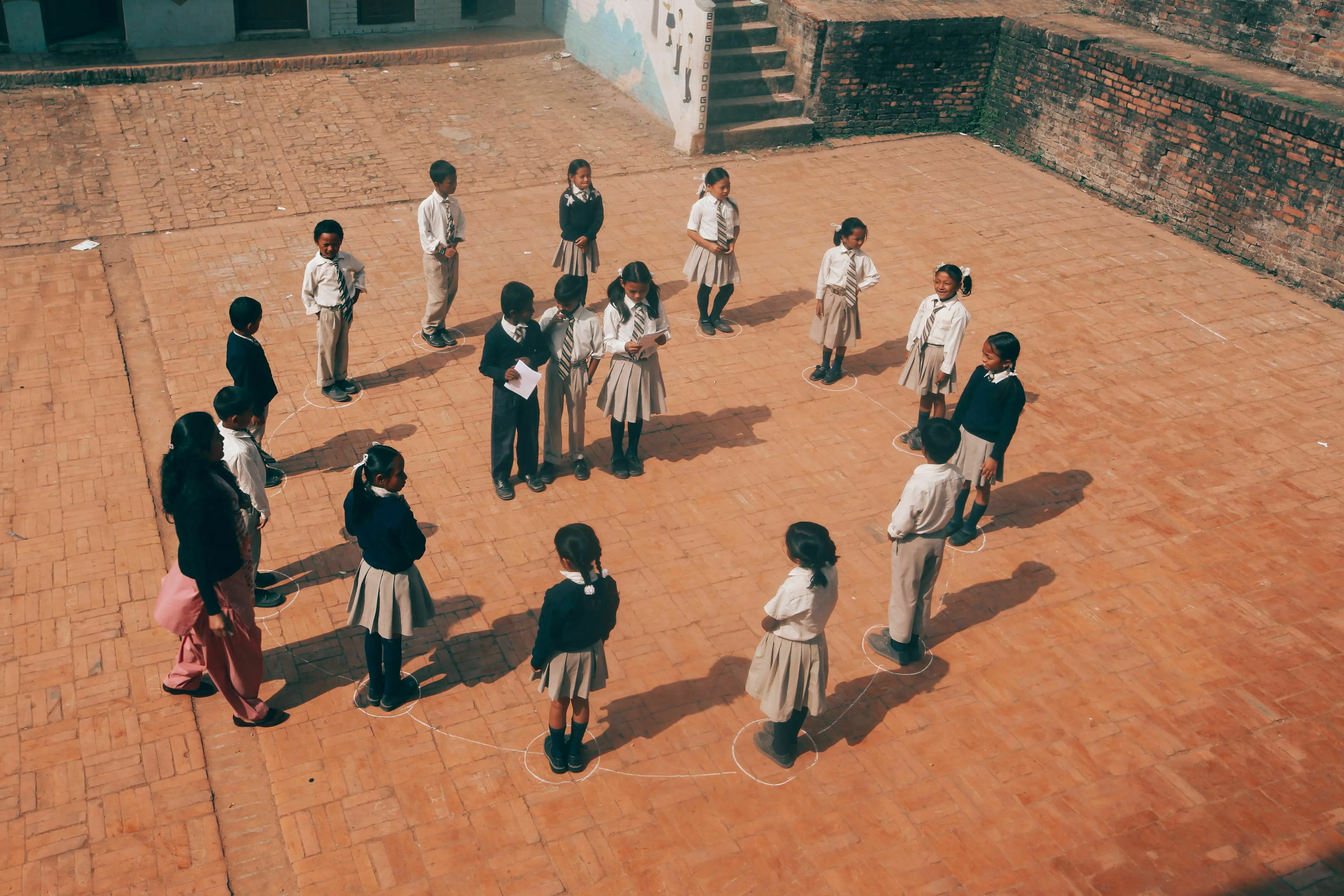 Children standing in a circle, representing what draws people to them for an extinct species quiz.