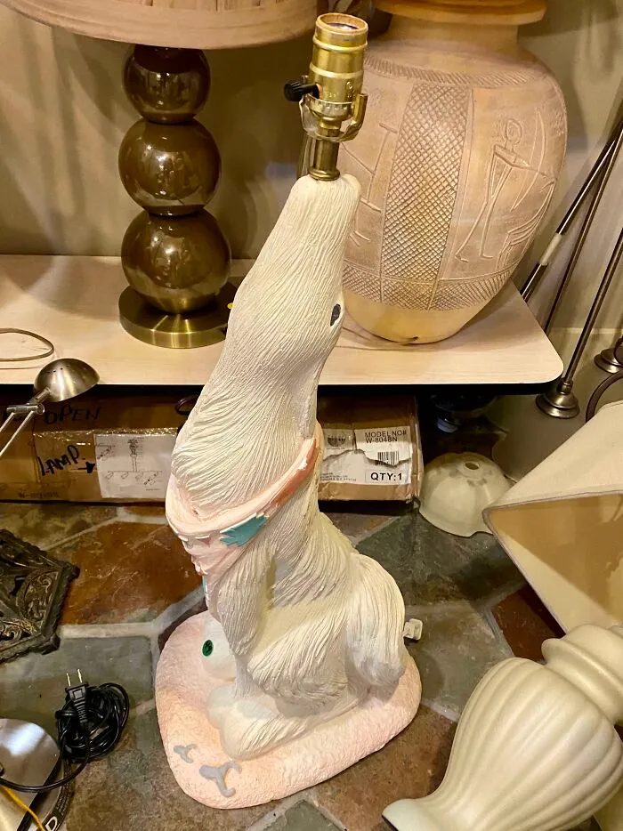 A bizarre furniture design lamp in the shape of a white animal, highlighting unique home decor.