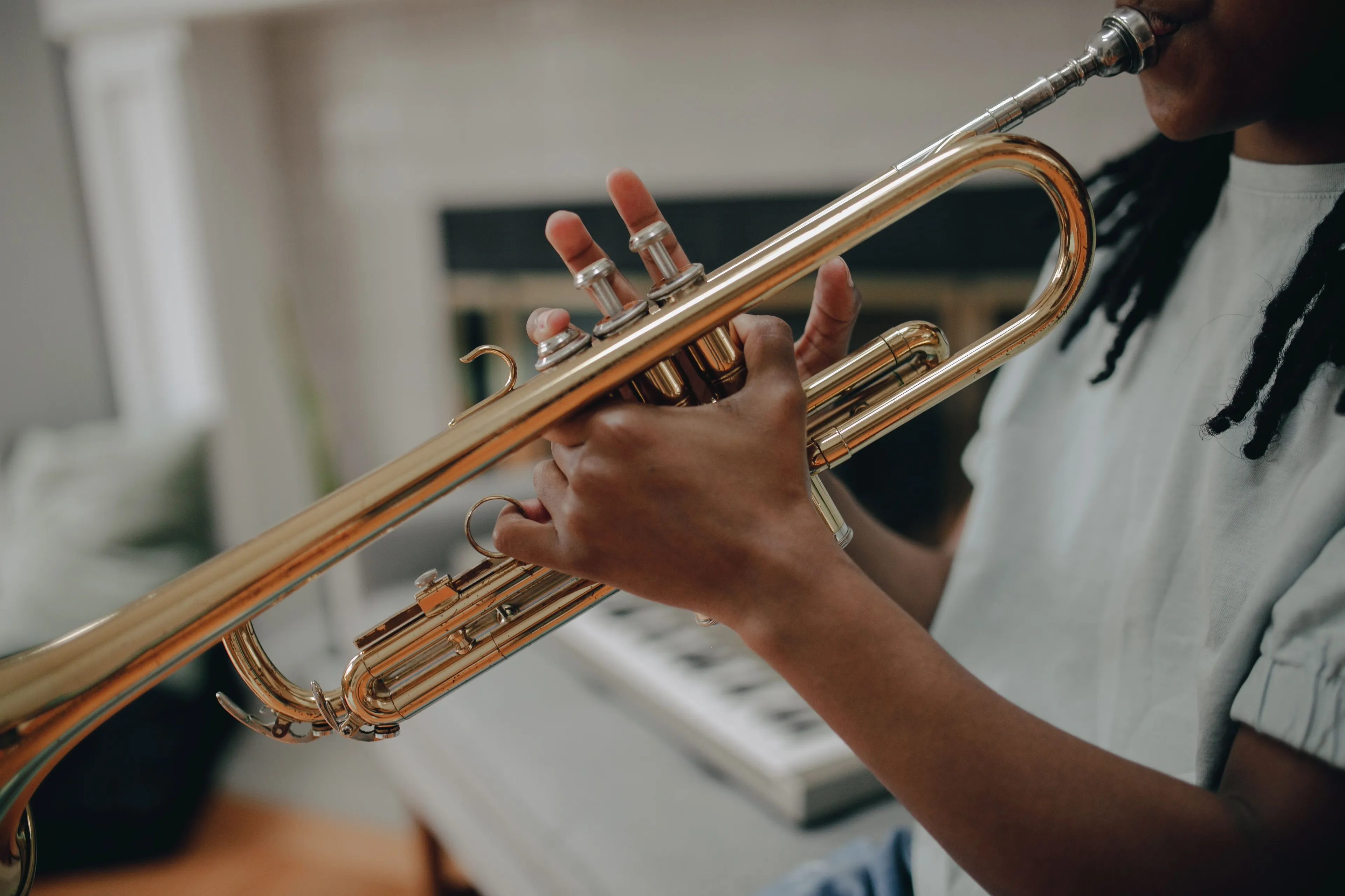 A person playing a Trumpet instrument, part of the woodwind family, for a music quiz question.