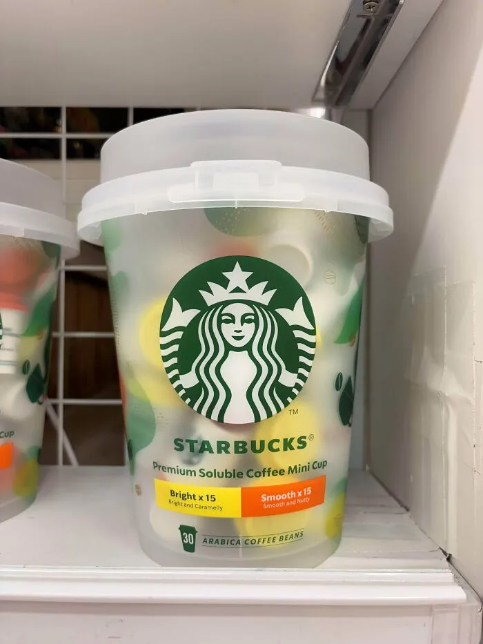 A container of Starbucks premium soluble coffee mini cups, showcasing consumerism in coffee products.