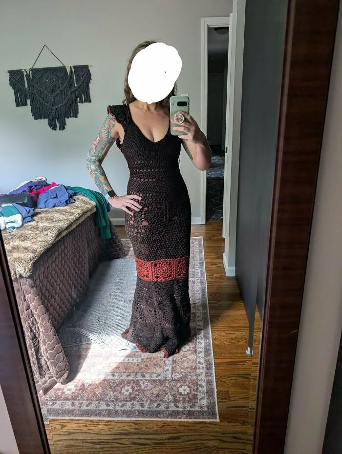 Woman wearing black and red long crochet dress creative crochet project