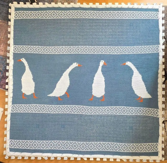 Crochet blanket with white geese on blue background creative crochet project