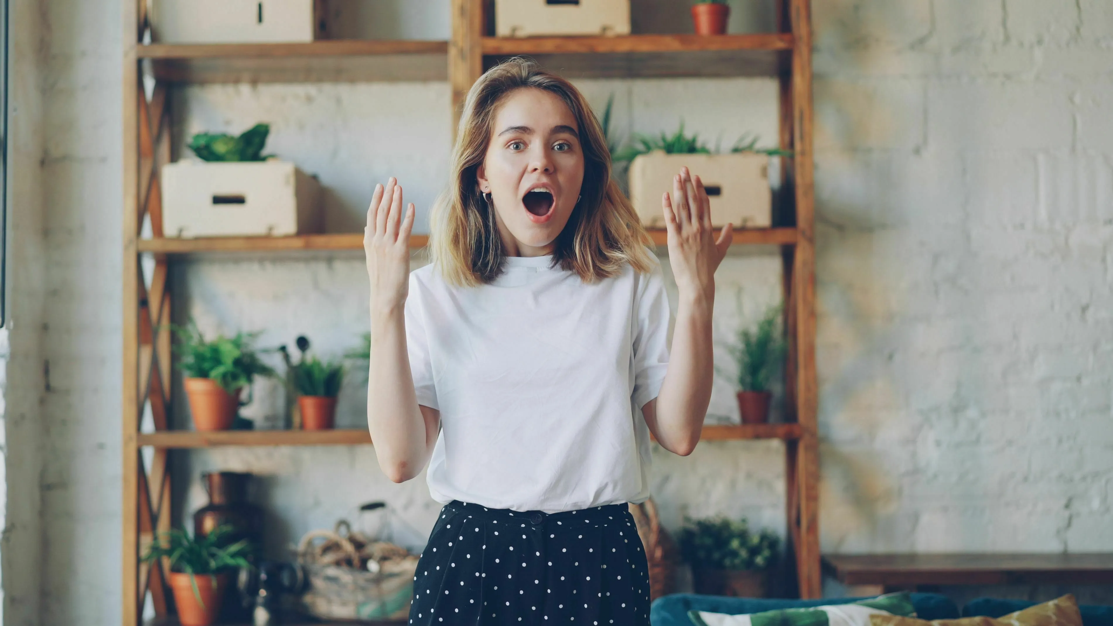 A woman looking surprised, indicating how she feels about surprise parties and seeking validation.