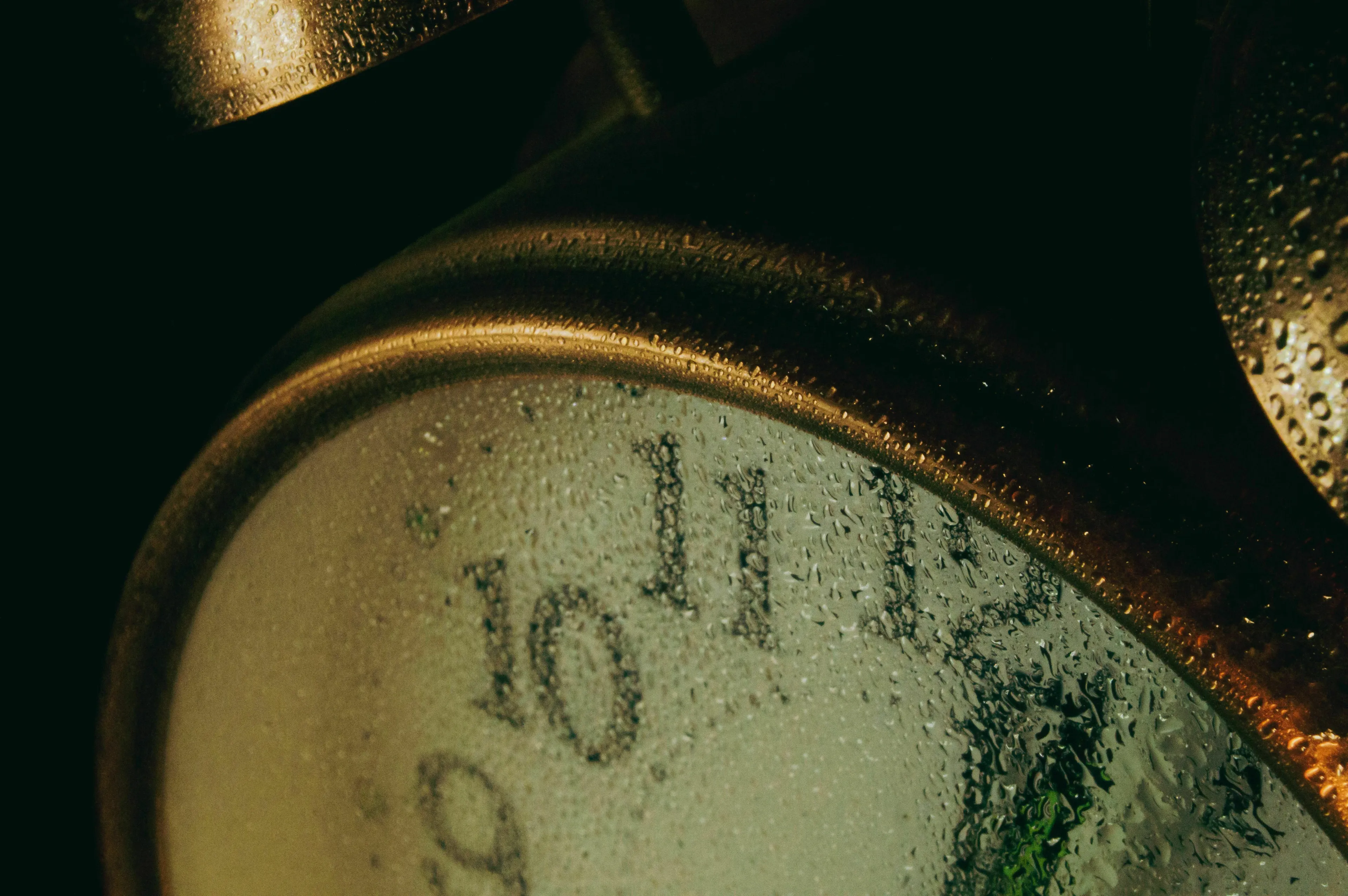 A close-up of a clock face covered in water droplets, illustrating how feelings change with a plan change.