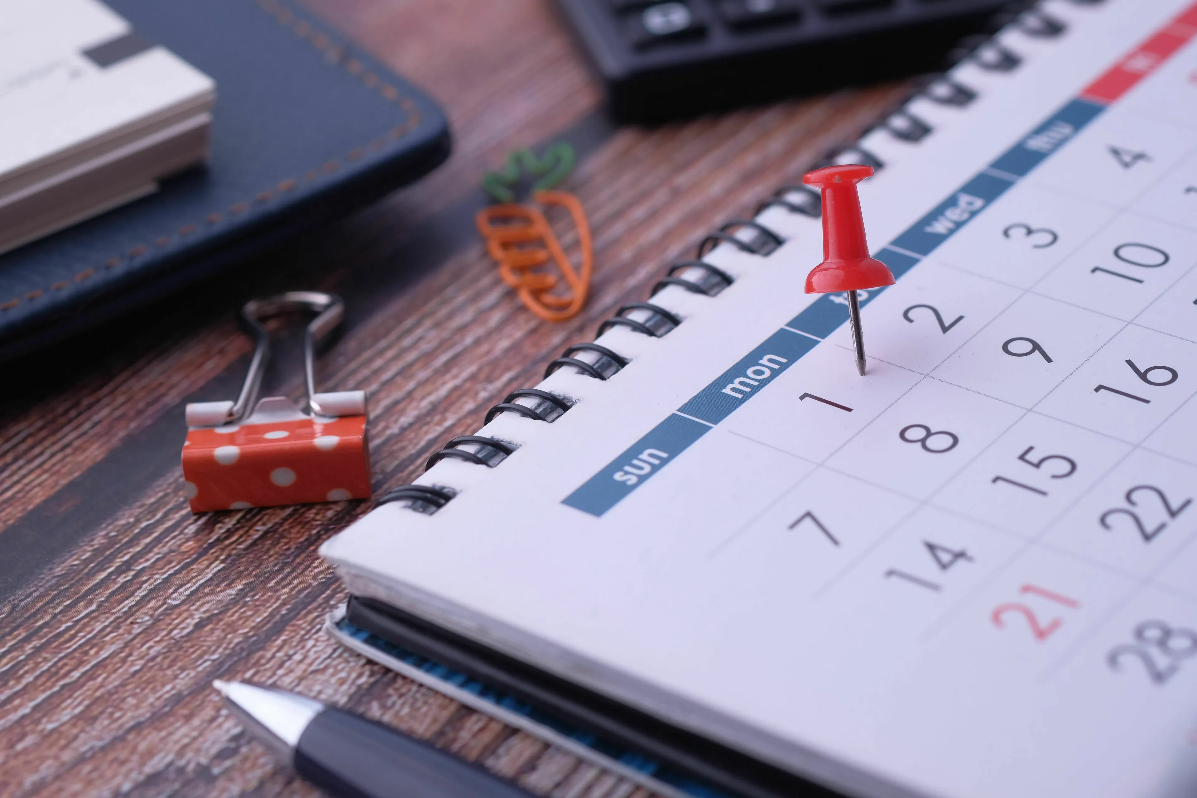 A red thumbtack marks a date on a calendar, representing a forgotten important event or seeking validation.