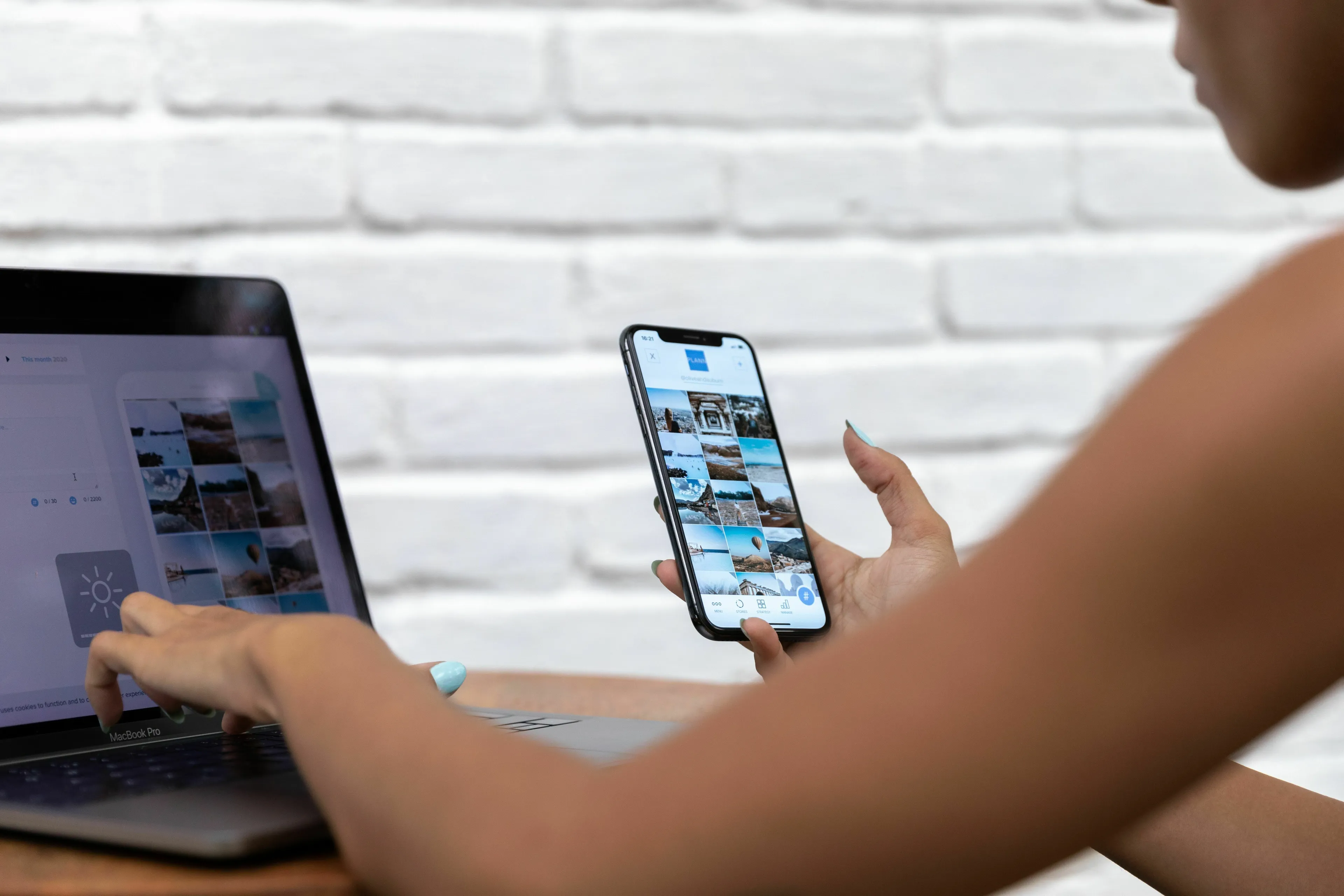 A person using a laptop and a smartphone to post online, representing the quiet response when seeking validation.