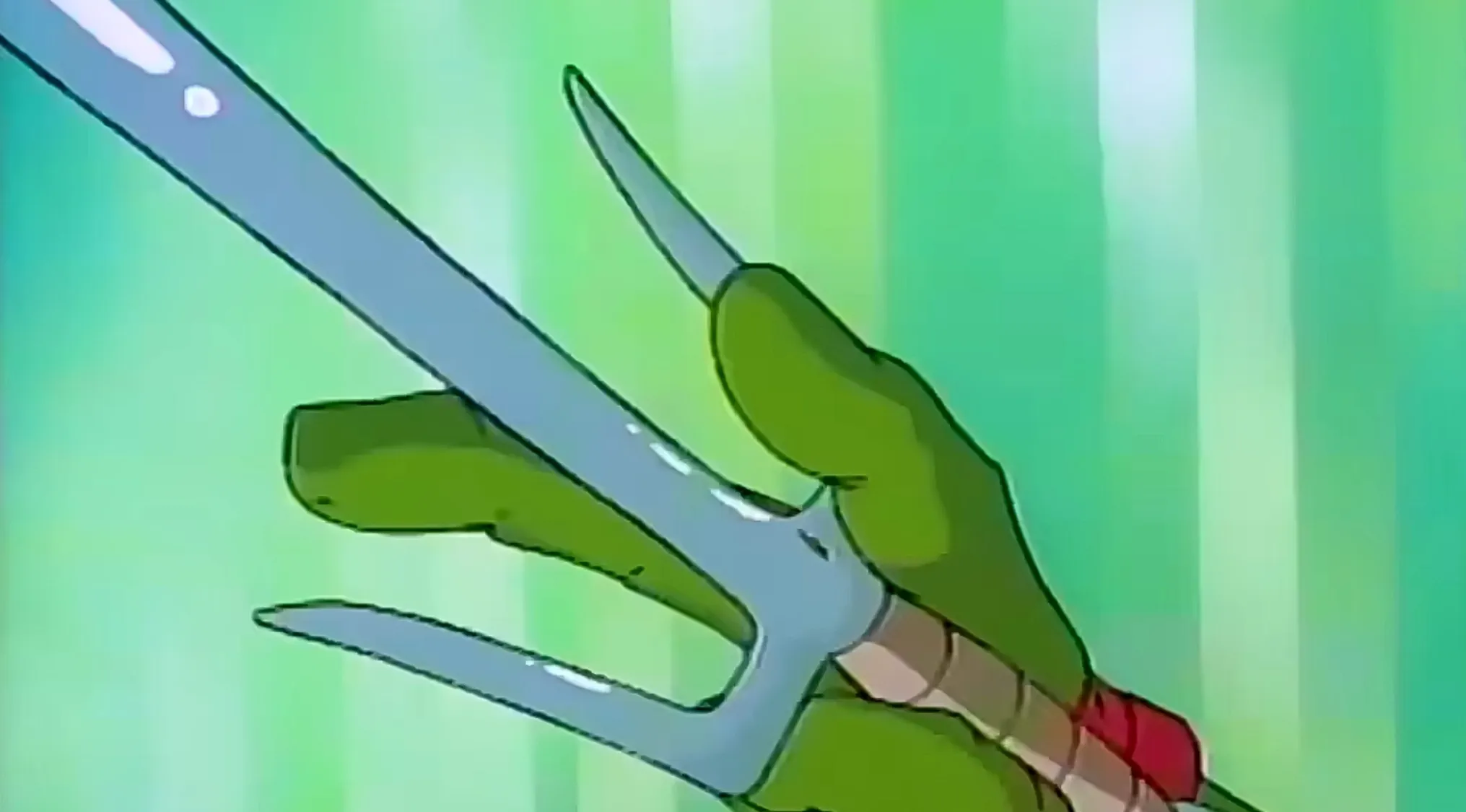 Saturday Morning Cartoon Trivia: Close-up of a green cartoon hand holding a sai, a formidable martial arts weapon.