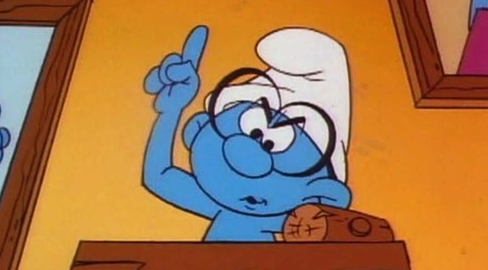 Brainy Smurf from the Saturday Morning Cartoon Trivia, raising his hand to answer a question.