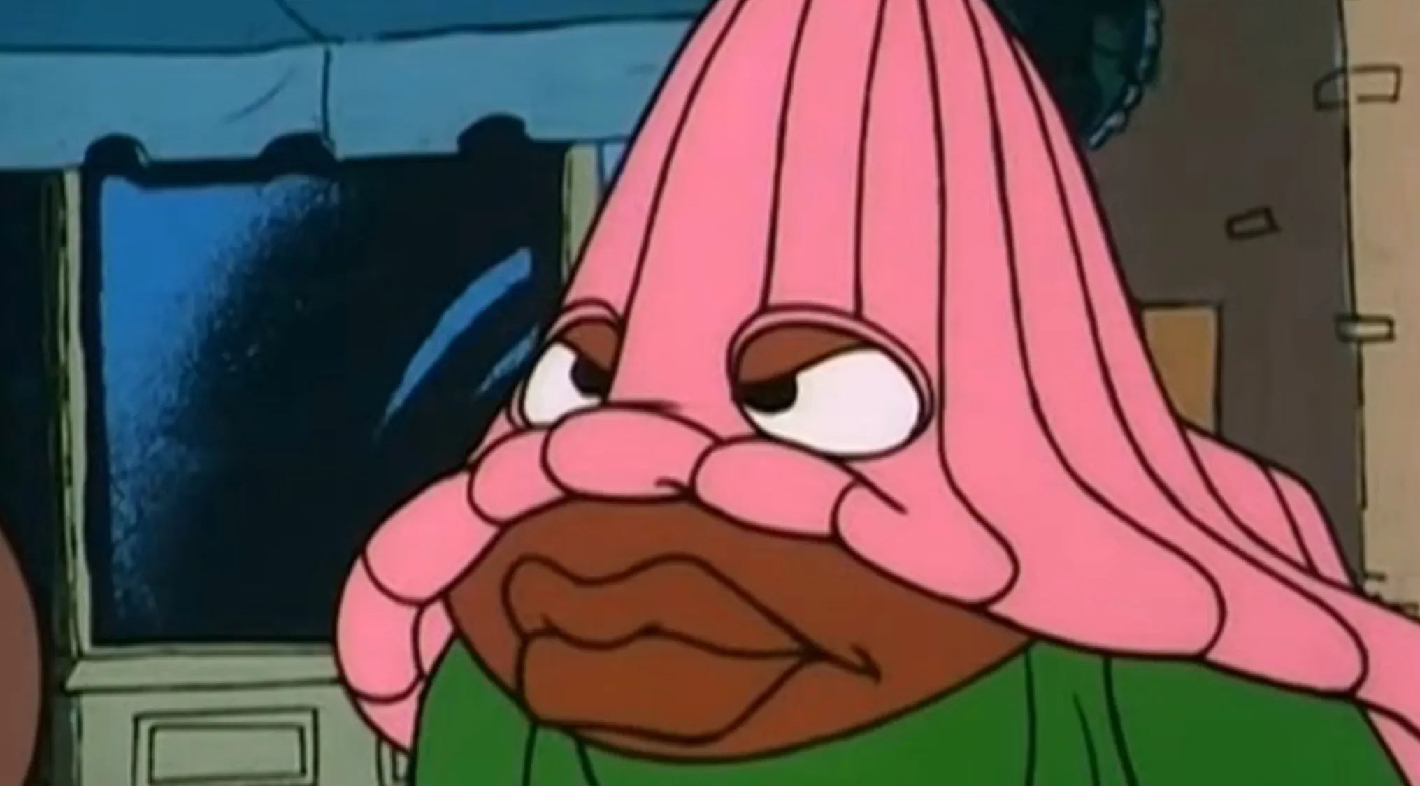 A character with a pink, ribbed head and large lips from a Saturday Morning Cartoon.