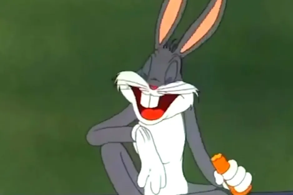 Bugs Bunny laughing and holding a carrot, a classic nemesis of Tweety Bird.