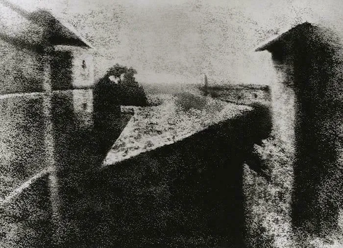 An early, grainy black and white photograph of a cityscape, representing fascinating timeline facts from history.