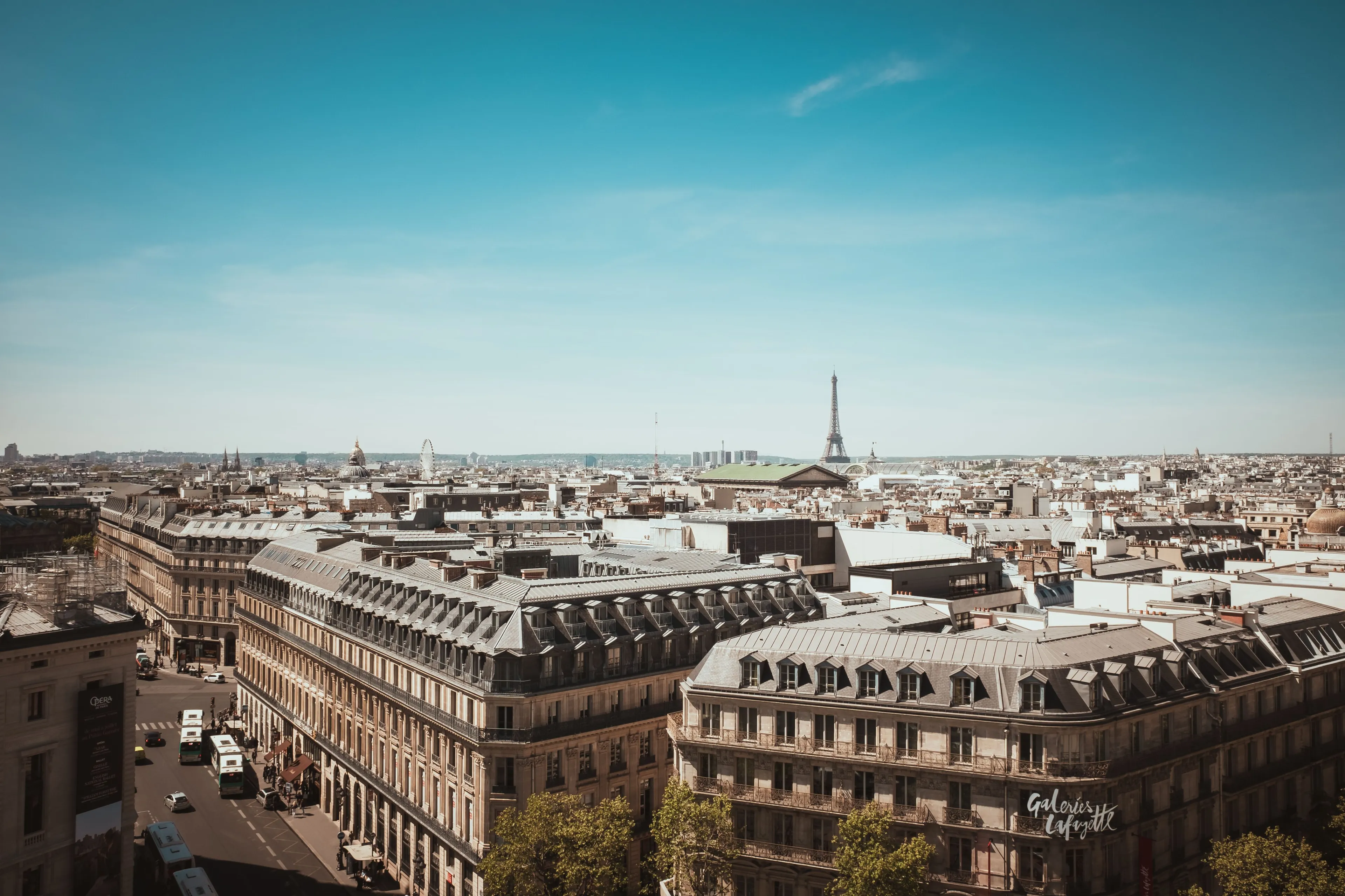 An aerial view of the beautiful city of Paris, France, with the iconic Eiffel Tower in the distance, a great vacation spot.