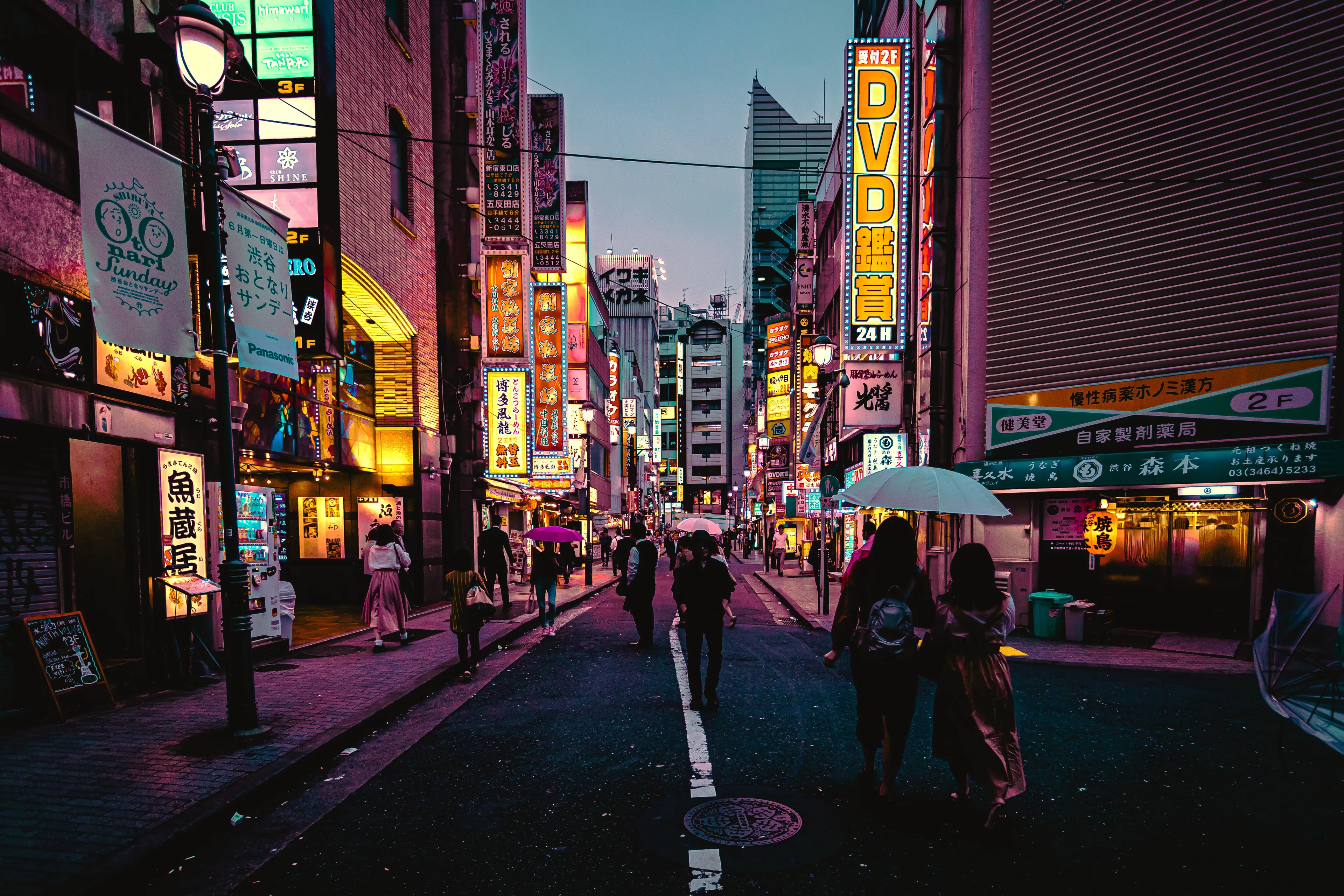 A vibrant street scene in Tokyo at dusk, with colorful neon signs and people walking, a popular vacation spot.