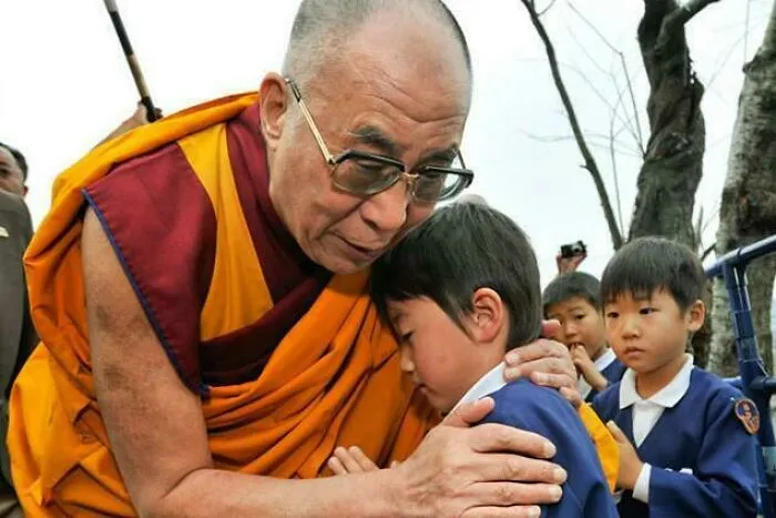 Dalai Lama hugging a child, illustrating timeline facts that change sense of history.