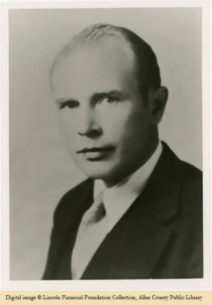 Black and white portrait of a man in a suit, reflecting a moment in history timeline facts.