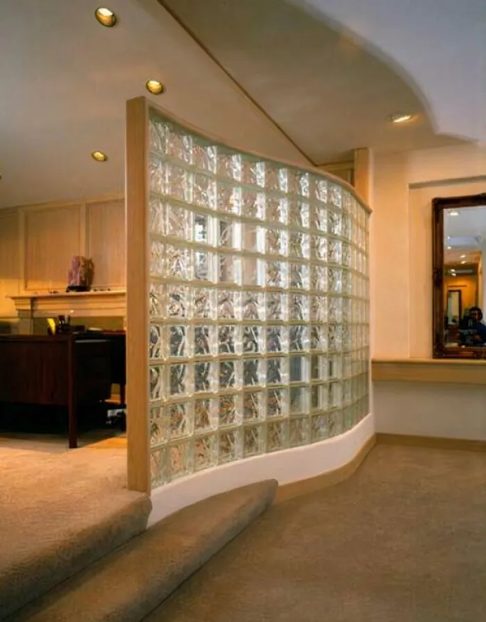 A curved glass block wall in an office setting, a common design element that might make you feel like you went through a time machine to the 90s.