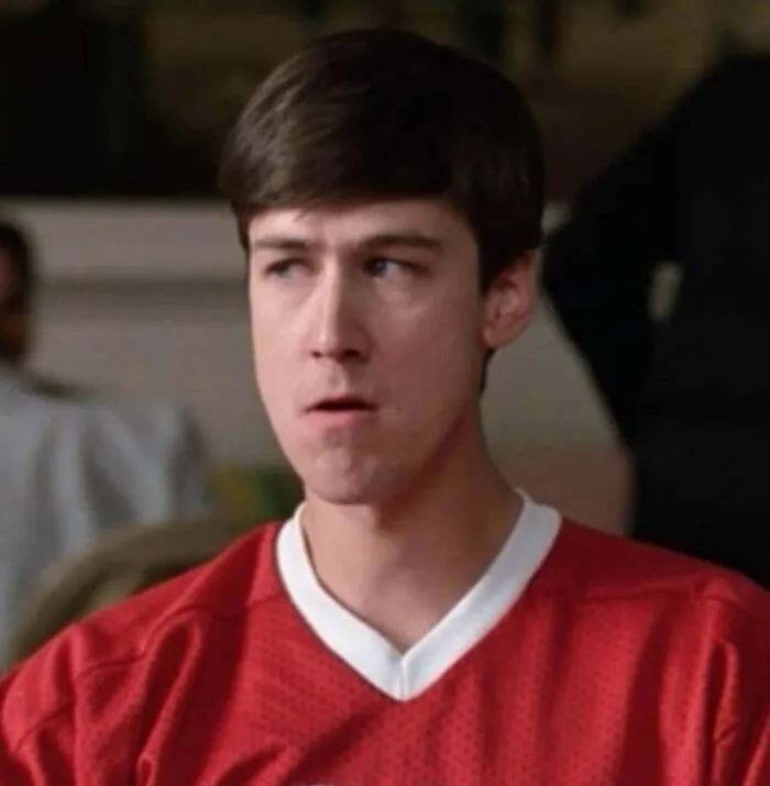 A man with a surprised expression in a red shirt, reflecting unique timeline facts and history.