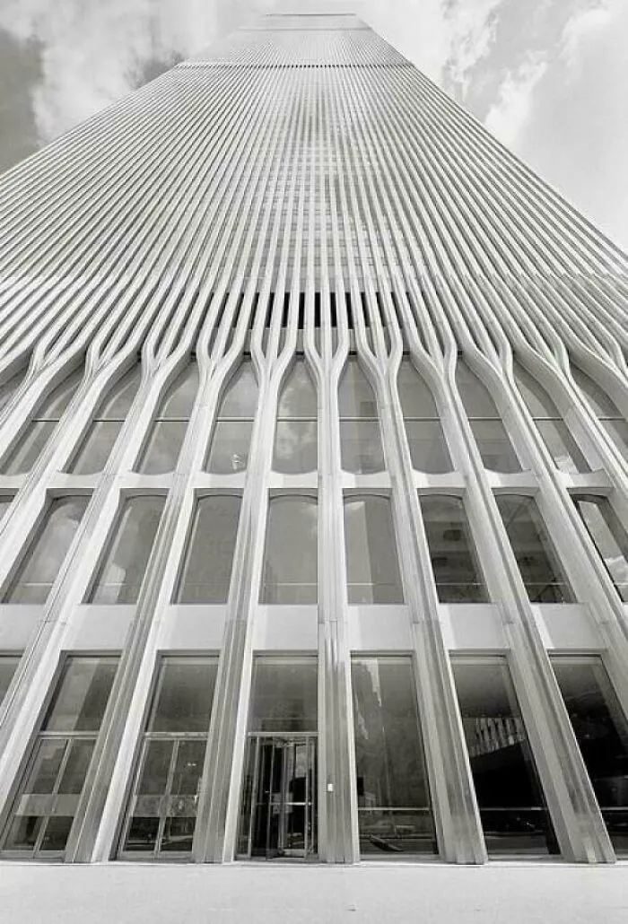 A low-angle, black and white shot of a skyscraper's exterior, a classic example of 1970s and 1980s architecture.