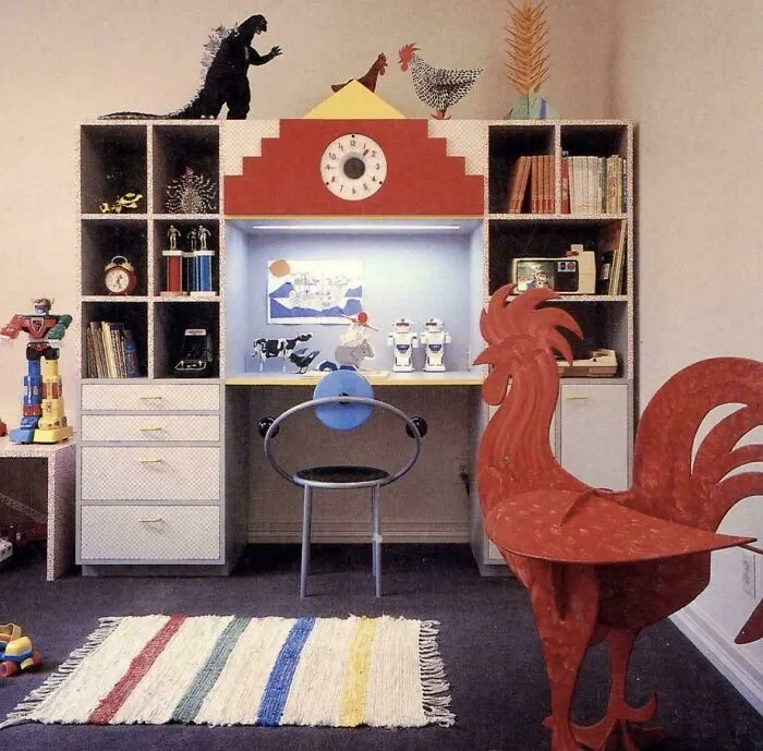 A child's room featuring 1970s and 1980s interior design with a desk, bookshelves, and various toys and decorations.
