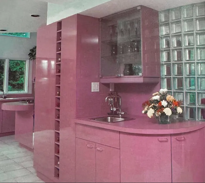 Pink kitchen with unique cabinets and glass block accents, a bold example of 1970s and 1980s interior design.