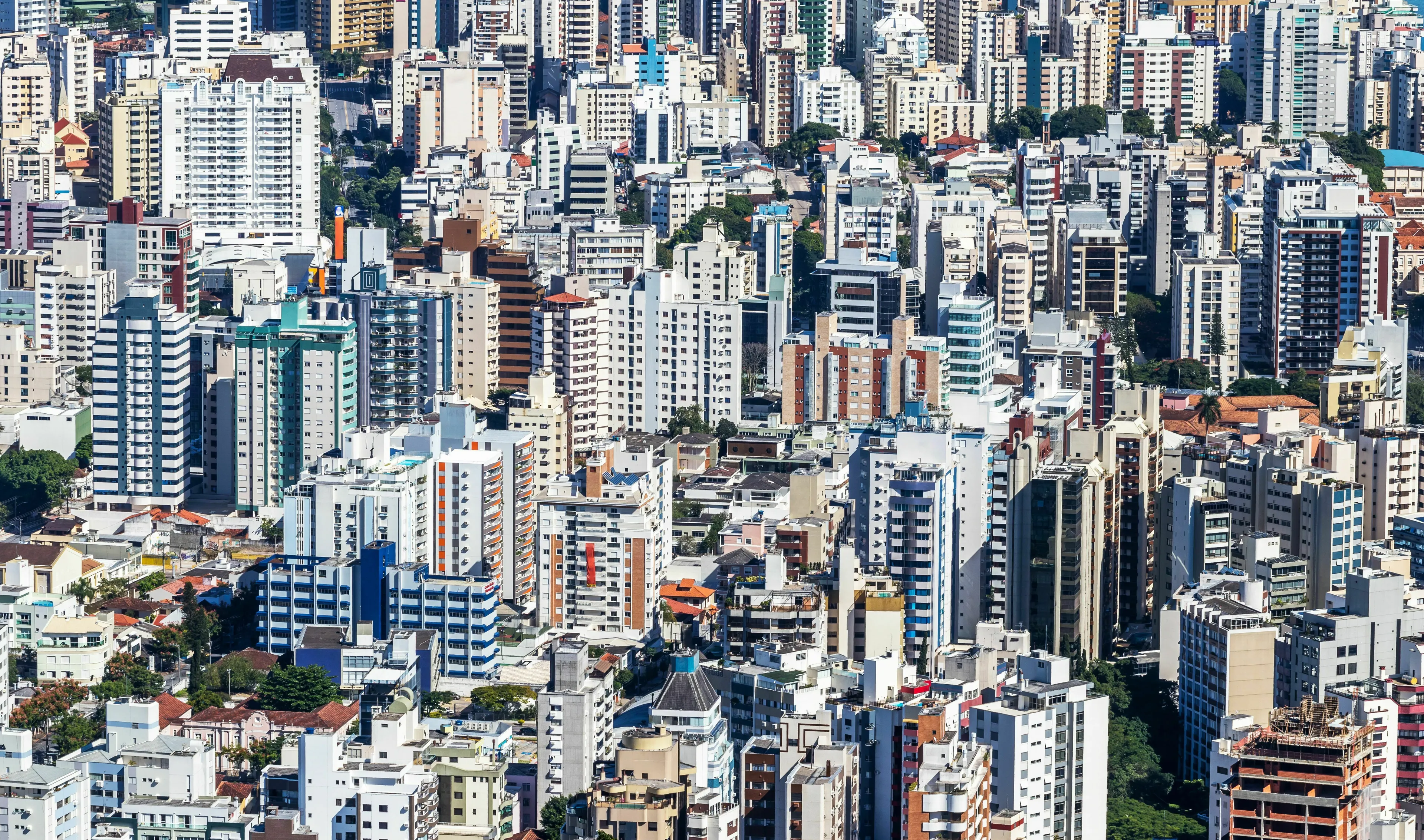 An aerial view of a dense urban landscape with numerous tall buildings, for the odd one out general knowledge challenge.