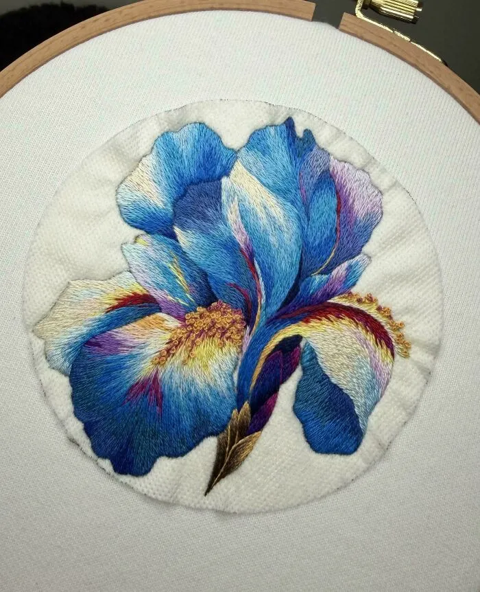 Intricate blue iris flower embroidery project
