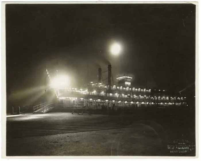 Historical photos: A brightly lit paddle steamer at night, reflecting on the water, showing a past that will remain alive.