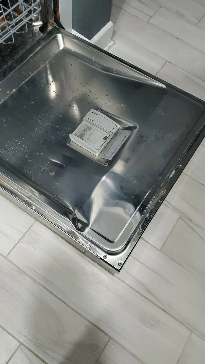 An open dishwasher door, showcasing a household item that might need help fixing problems.