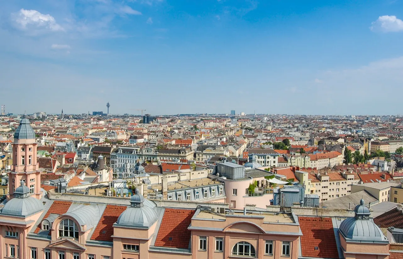 A panoramic view of Vienna, a capital city with historical significance to four empires, showing rooftops and architecture.
