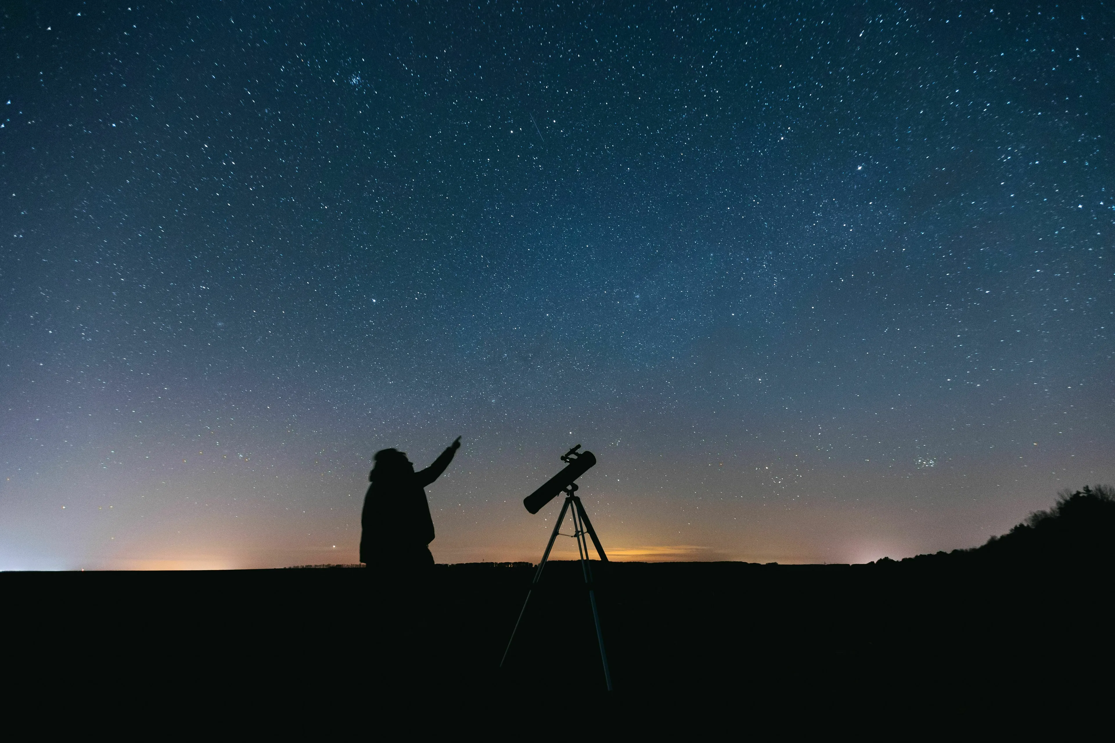 General knowledge quiz about planets, a silhouette of a person pointing to a starry night sky with a telescope.