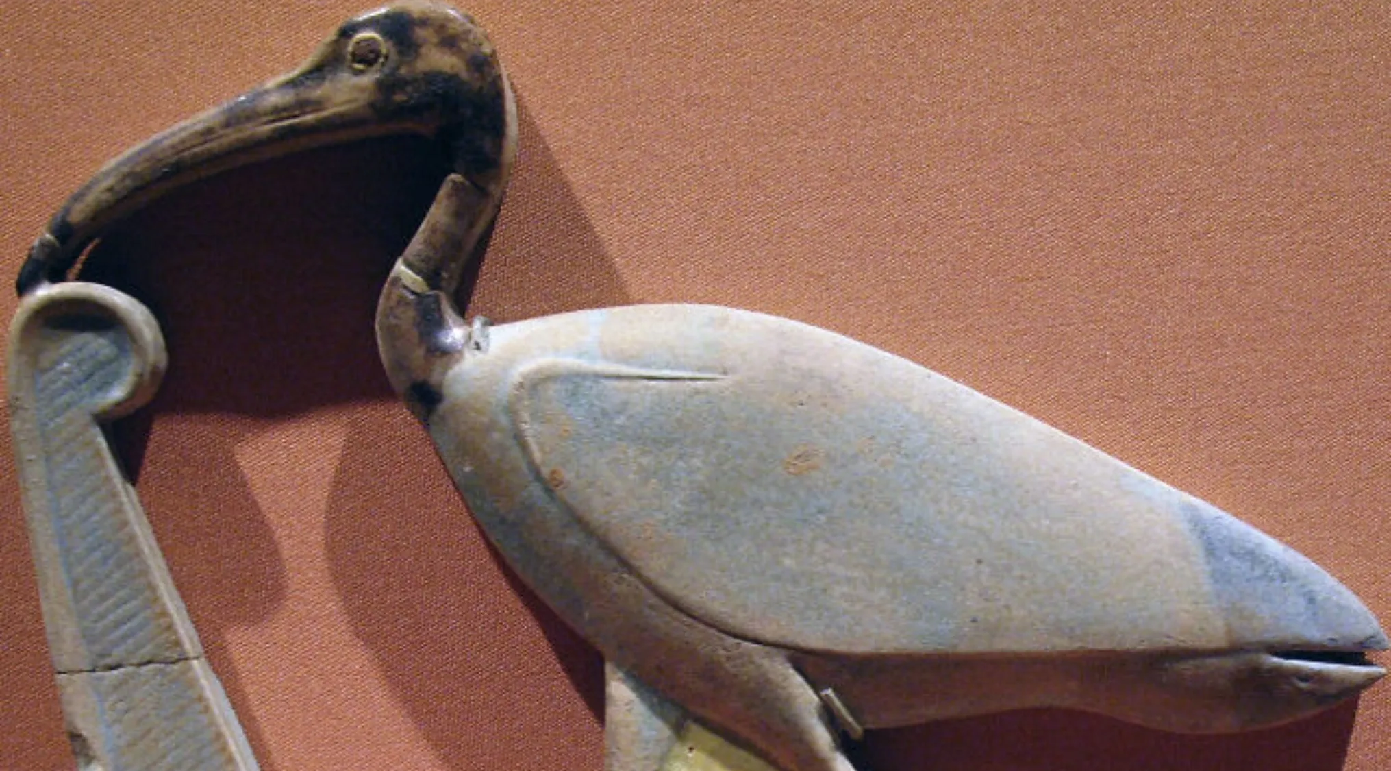 An ancient Egyptian artifact, a long-legged wading bird sculpture, likely an ibis, revered in Egypt, for general knowledge.