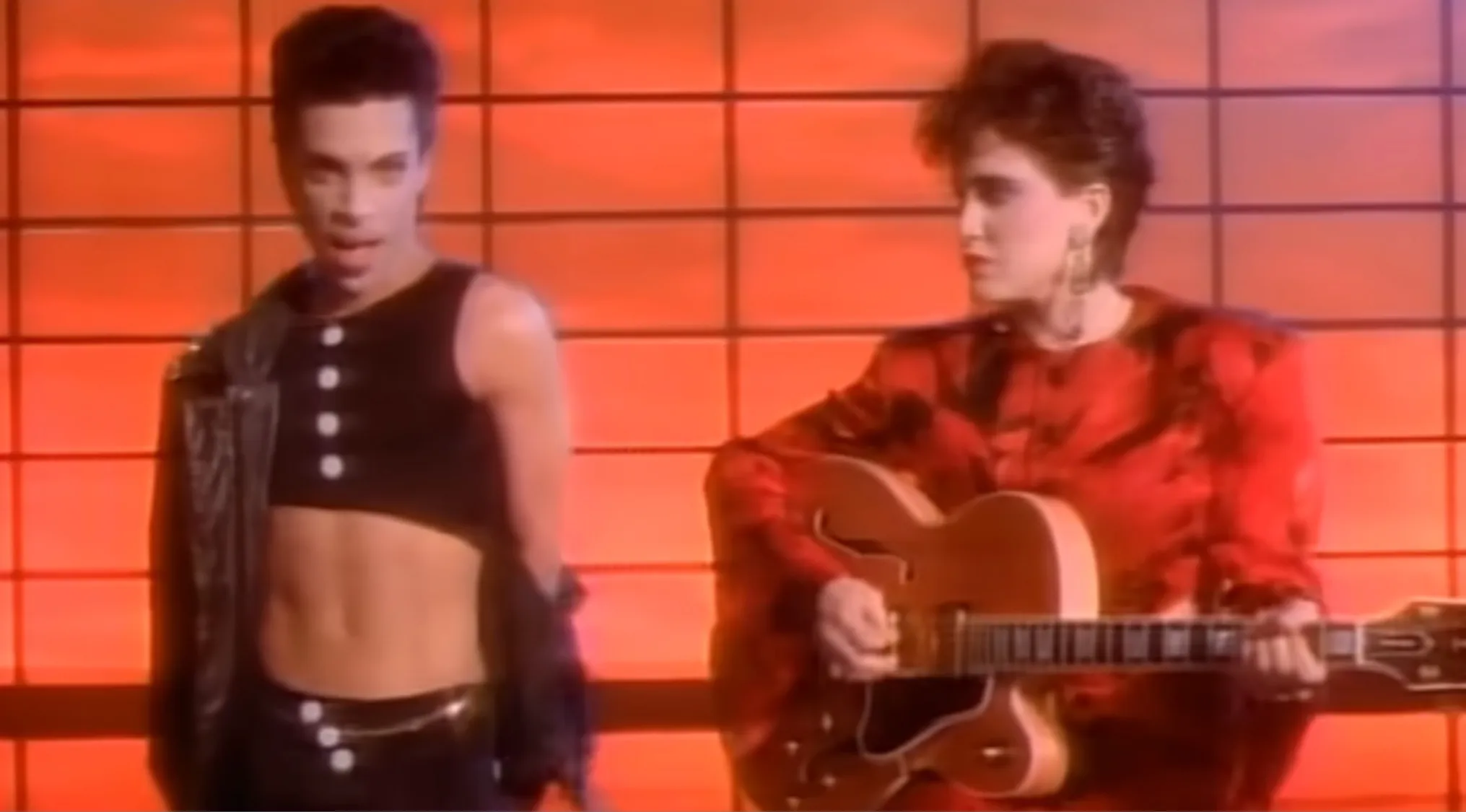 Prince and the Revolution in a music video snapshot, performing a song for the music quiz.