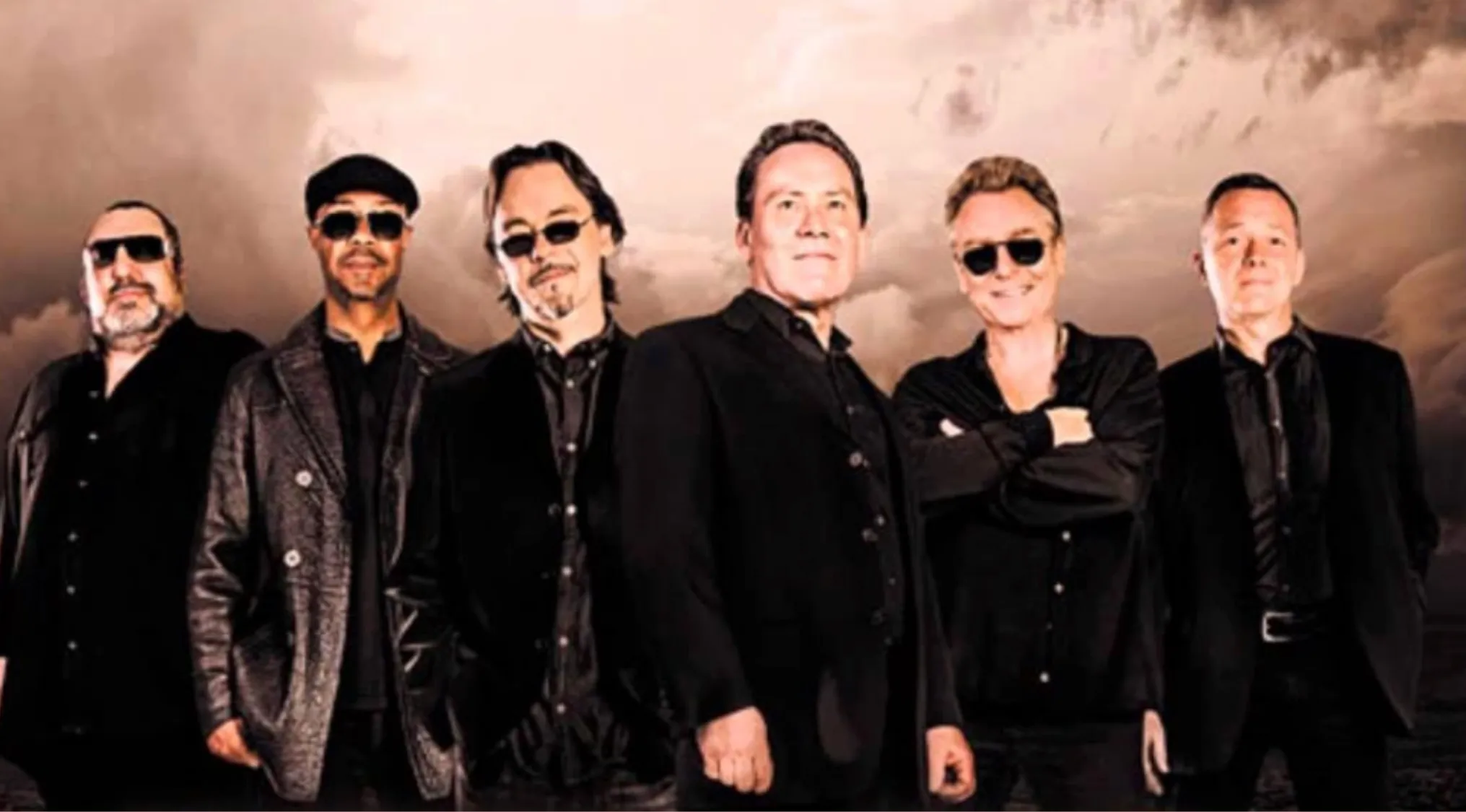 A group of men from a band posing for the A-To-Z Music Quiz, U section.