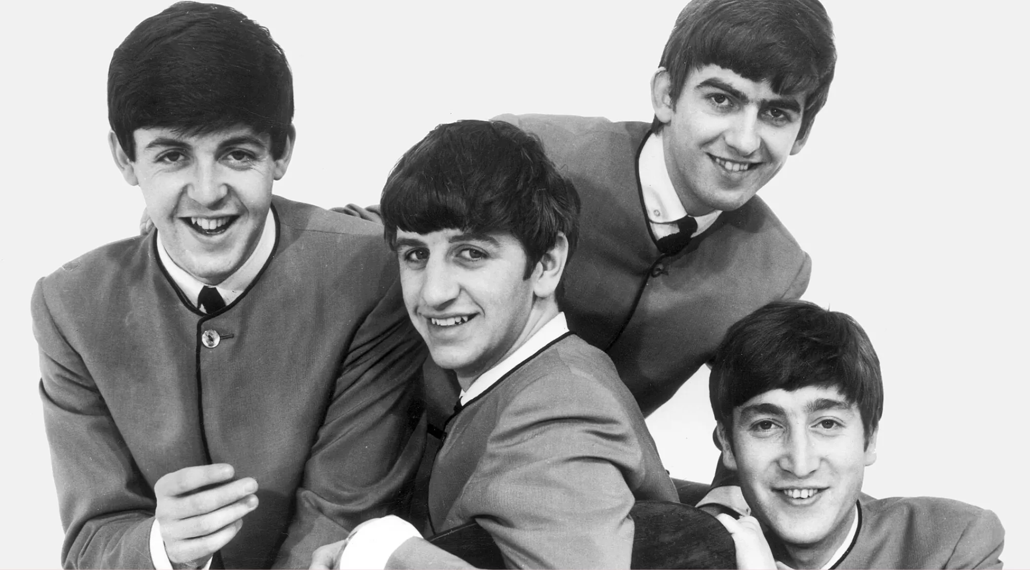 The Beatles in a classic black and white pose, part of a music quiz.