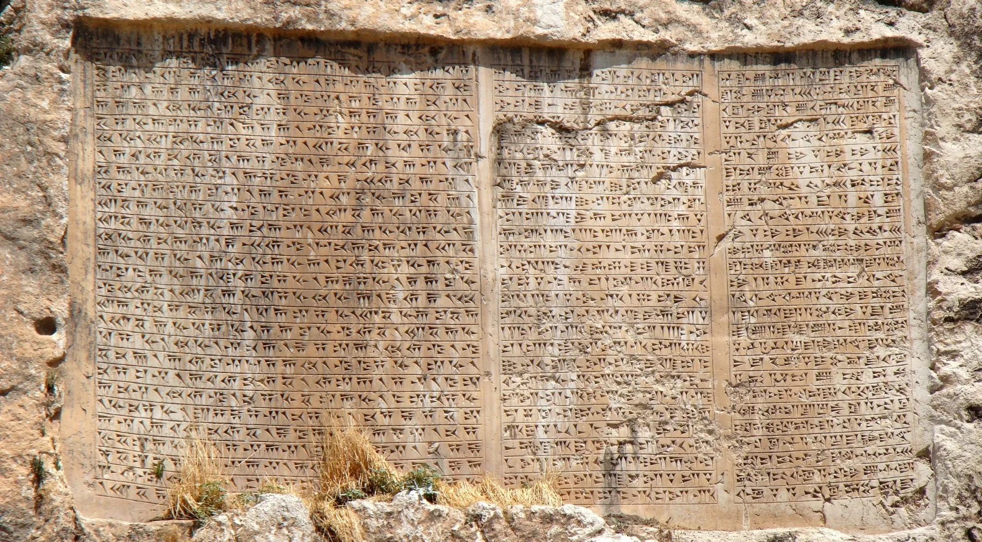 Ancient Civilizations: Close-up of cuneiform writing carved into a stone tablet, showcasing one of the world's earliest systems of writing.