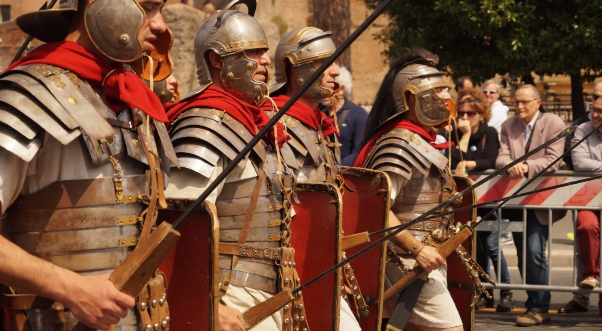 Roman soldiers in ancient civilization costumes, with helmets, armor, and spears, depicting a legion.