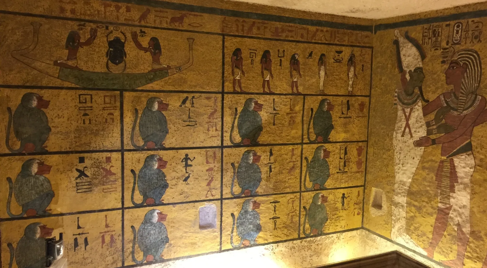 Ancient Egyptian tomb paintings, featuring King Tut, hieroglyphs, and baboons, hint at the Curse of the Pharaohs.